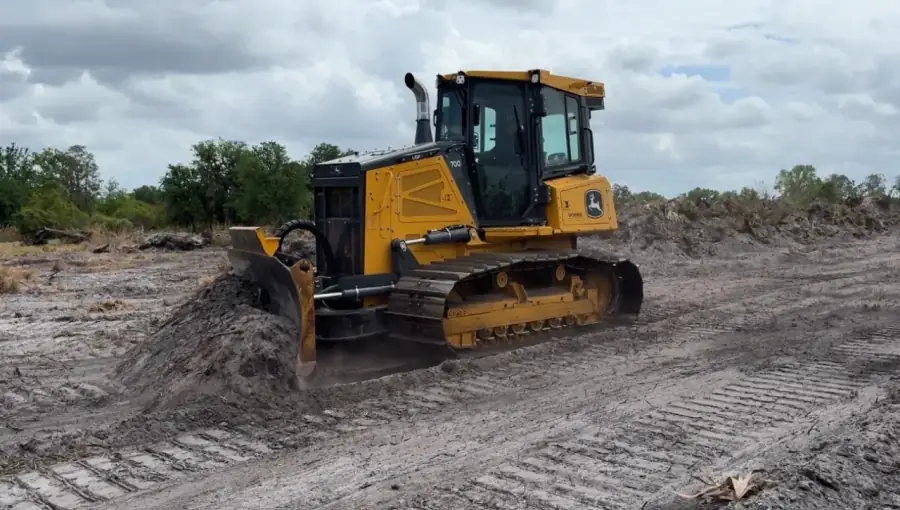 Southern Environmental Group forestry mulcher and bulldozer at land clearing site in Tampa Bay , John Deere 700L LGP crawler dozer grading and leveling site after tree removal