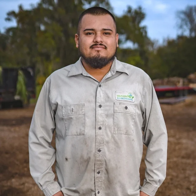 Jesus Montana standing outdoors in a branded work shirt, representing the hard-working local professionals you will read about in the About Southern Environmental Group section.