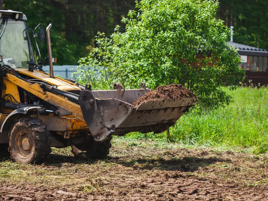 Southern Environmental heavy loader moving soil and debris during a land clearing project in Tampa, Florida.