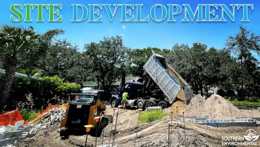 Southern Environmental dump truck and skid steer performing site development and grading on a construction lot.