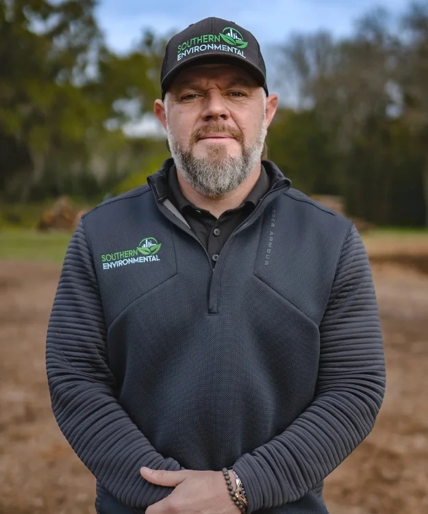 Adam Snyder, owner and founder, wearing branded apparel on a job site, highlighting the local leadership you will find when learning about Southern Environmental Group.